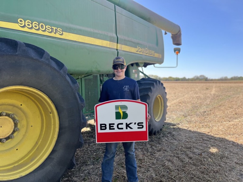 Holding a Beck’s sign in front of a John Deere 9660 STS combine