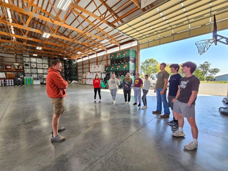 Cory Robinson leading a group tour inside the CR Seeds & Services warehouse