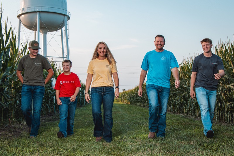 The Robinson family walking between rows of corn in Missouri
