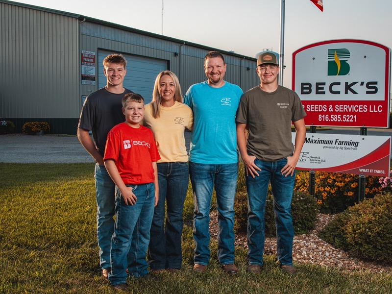 The Robinson family of CR Seeds & Services in front of their warehouse and Beck’s Hybrids sign in Winston, MO