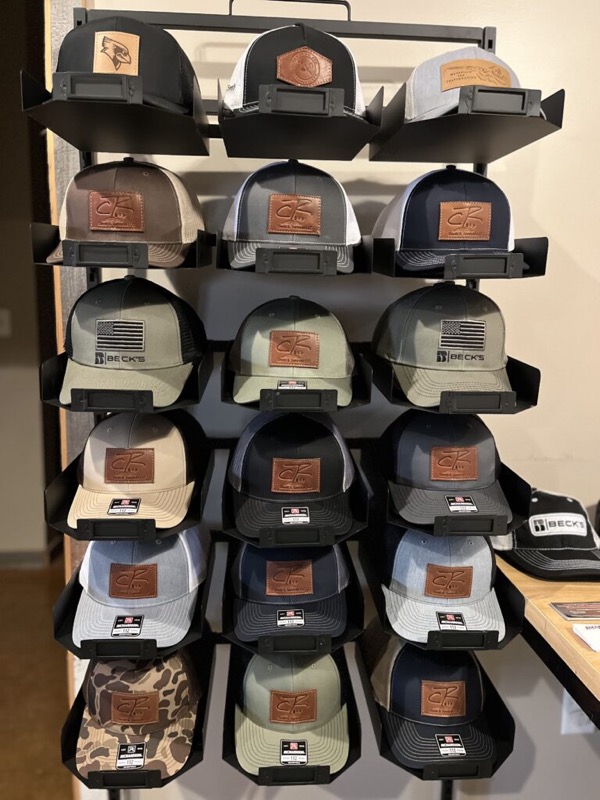 A display of CR Seeds & Services trucker hats