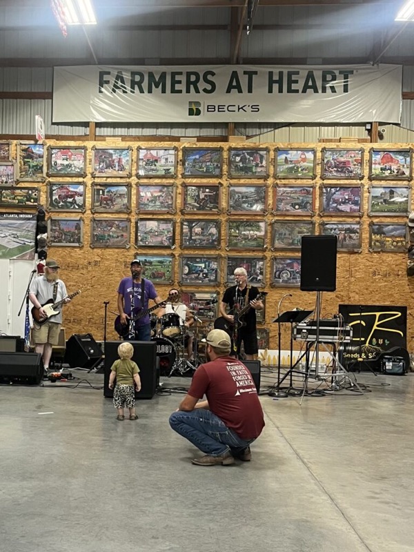 A live band playing at a customer event in the CR Seeds & Services warehouse
