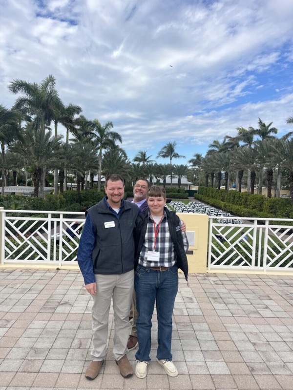 Cory Robinson with an attendee at a Maximum Farming conference
