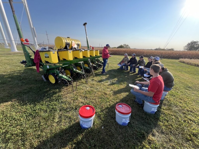 Students at a field day with a planter demonstration