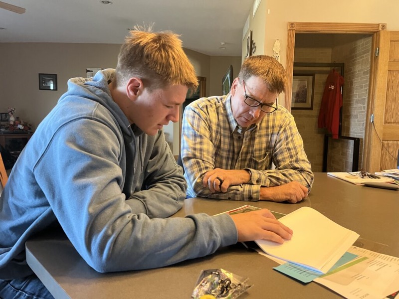 Reviewing seed and field plans with a customer at the kitchen table