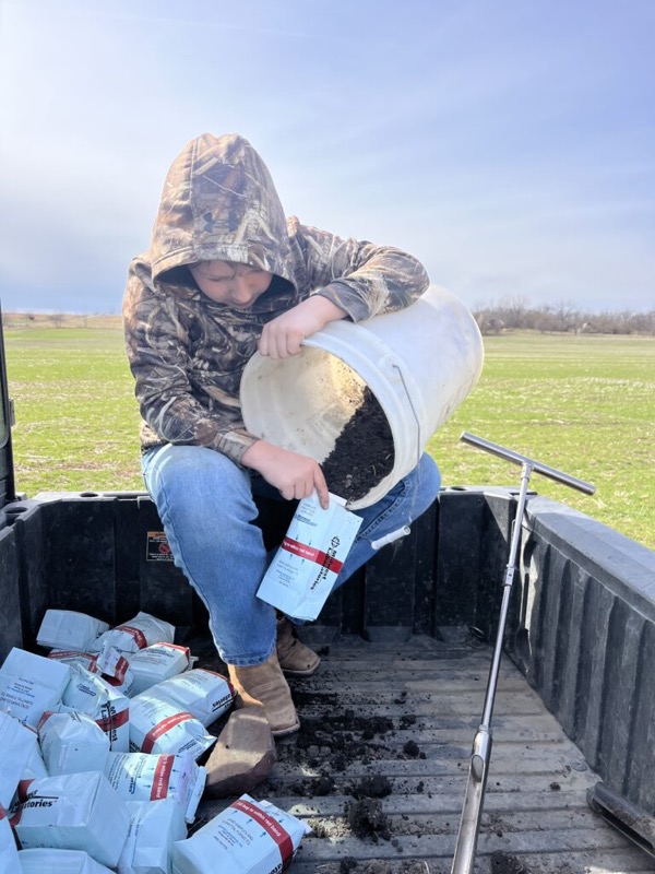 Bagging soil samples in the bed of a truck